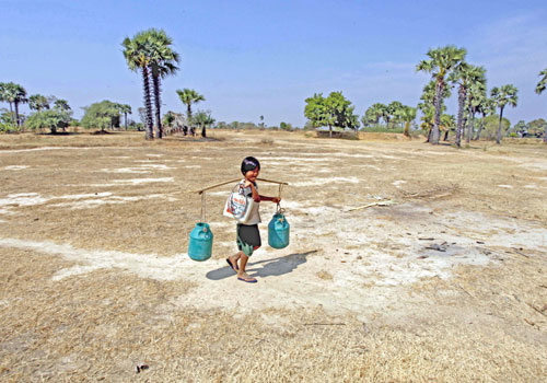 Children carry water for their family to use during the dry season in Kow Poe Kee village, Kayin State. Photo: EPA