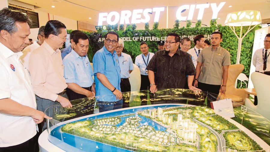 Johor Menteri Besar Datuk Seri Mohamed Khaled Nordin viewing an exhibition at the Iskandar Malaysia open house in Johor Baru last year. Iskandar Malaysia is leading the way in the low-carbon drive in Malaysia and the region.