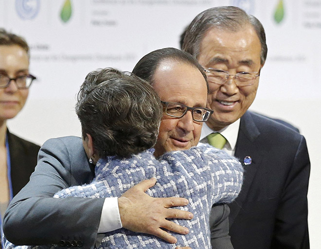 Hollande embraces Christiana Figueres, executive secretary of the UN Framework Convention on Climate Change, as United Nations Secretary-General Ban Ki-moon looks on at the final plenary session at the World Climate Change Conference 2015 (COP21) at Le Bourget, near Paris. — Reuters photo