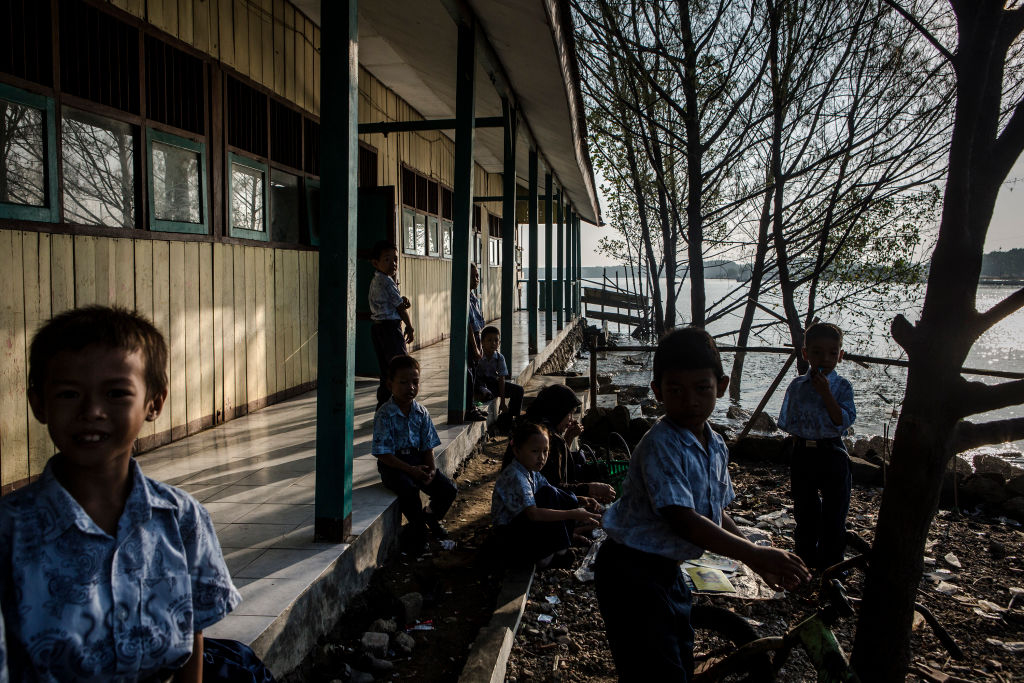 Students gather at their school surrounded by rising sea levels at Bedono village