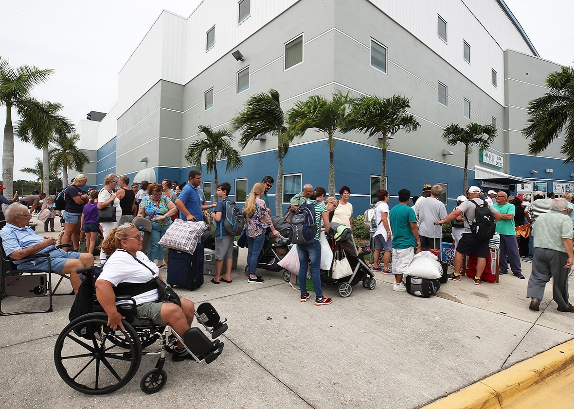 People wait to enter the Germain Arena, which has served as a shelter from Hurricane Irma, on Saturday in Estero, Florida. Even as economic losses from disasters have risen, the number of human lives lost has dropped.