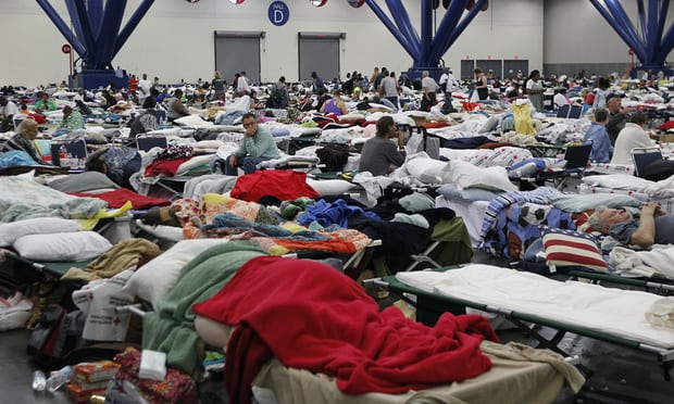 People rest at the George Brown Convention Centre which has been opened as a shelter in Houston, Texas, after Hurricane Harvey. Photograph: Xinhua/Barcroft Images