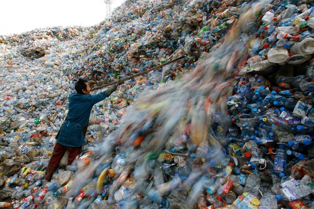 A worker sorts plastic bottles at a recycling centre on the outskirts of Wuhan, Hubei province, China. Photograph: Jie Zhao/Corbis/Getty Images