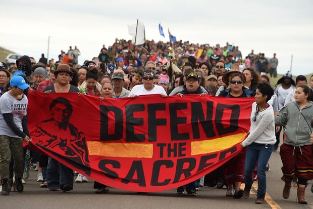  Native Americans march to a sacred burial ground disturbed by bulldozers building the Dakota Access Pipeline. Protesters were attacked by dogs and sprayed with a respiratory irritant when they arrived at the site. Photograph: Robyn Beck/AFP/Getty Images