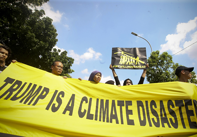 Protest banner outside the US Embassy says that Trumph is a climate disaster during protest held by Greenpeace Indonesia. Image: Yudha Baskoro/Jakarta Globe