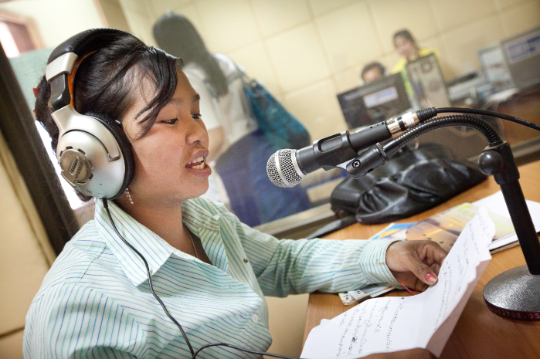 A radio presenter broadcasts educational programming in Lao PDR. The media have a crucial role to play in building consensus for climate action. Photo: UNDP Lao PDR