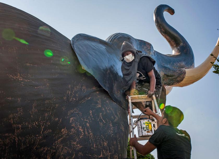 Sculptors put the finishing touches on one of seven paper mache elephant sculptures on display in exhibit ‘We Love Our Momos’ at Mahabandoola Park, Yangon. Nyan Zay Htet/ The Myanmar Times