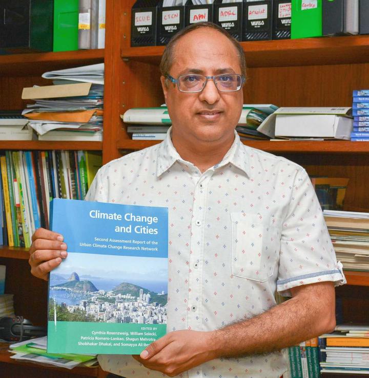 DR. SHOBHAKAR DHAKAL WITH HIS NEW PUBLICATION "CLIMATE CHANGE AND CITIES: SECOND ASSESSMENT REPORT OF THE URBAN CLIMATE CHANGE RESEARCH NETWORK. " CREDIT: ASIAN INSTITUTE OF TECHNOLOGY (AIT)