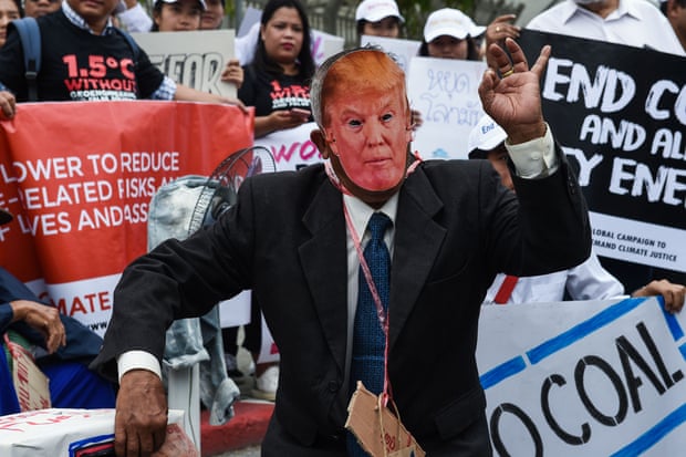 An environmental activist wearing a face mask depicting US President Donald Trump takes part in a demonstration in front of the United Nations building in Bangkok. Photograph: Lillian Suwanrumpha/AFP/Getty Images
