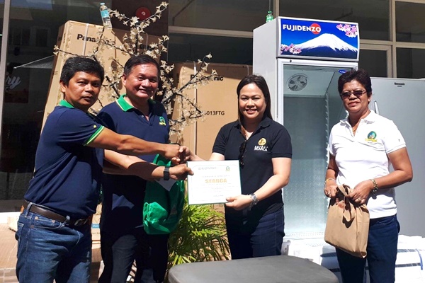 LAMAC MPC officials Mr. Richard Obaner (leftmost), Vice-Chair, and Mr. Delfin Tuguib (second from left), Chair, together with Ms. Maria Elena Limocon (rightmost), LAMAC MPC General Manager, presents the certificate of appreciation for the provision of equipment to The Dairy Box - Cebu to Ms. Nancy Landicho, SEARCA Program Specialist and OIC.