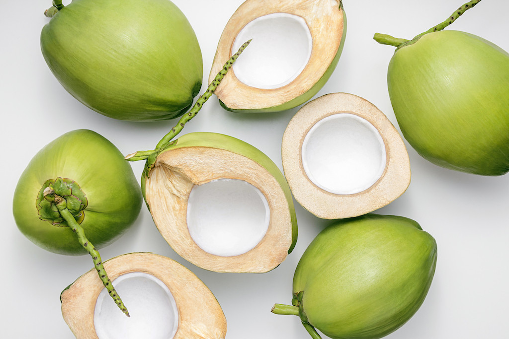 Fresh young coconuts on a white background (Shutterstock/SEE D JAN)