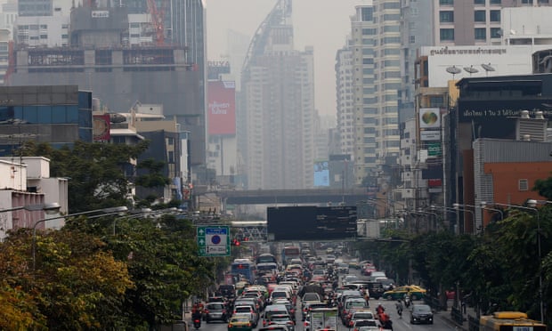 Traffic makes its way along a road as heavy smog lingers in the air in Bangkok. Photograph: Narong Sangnak/EPA