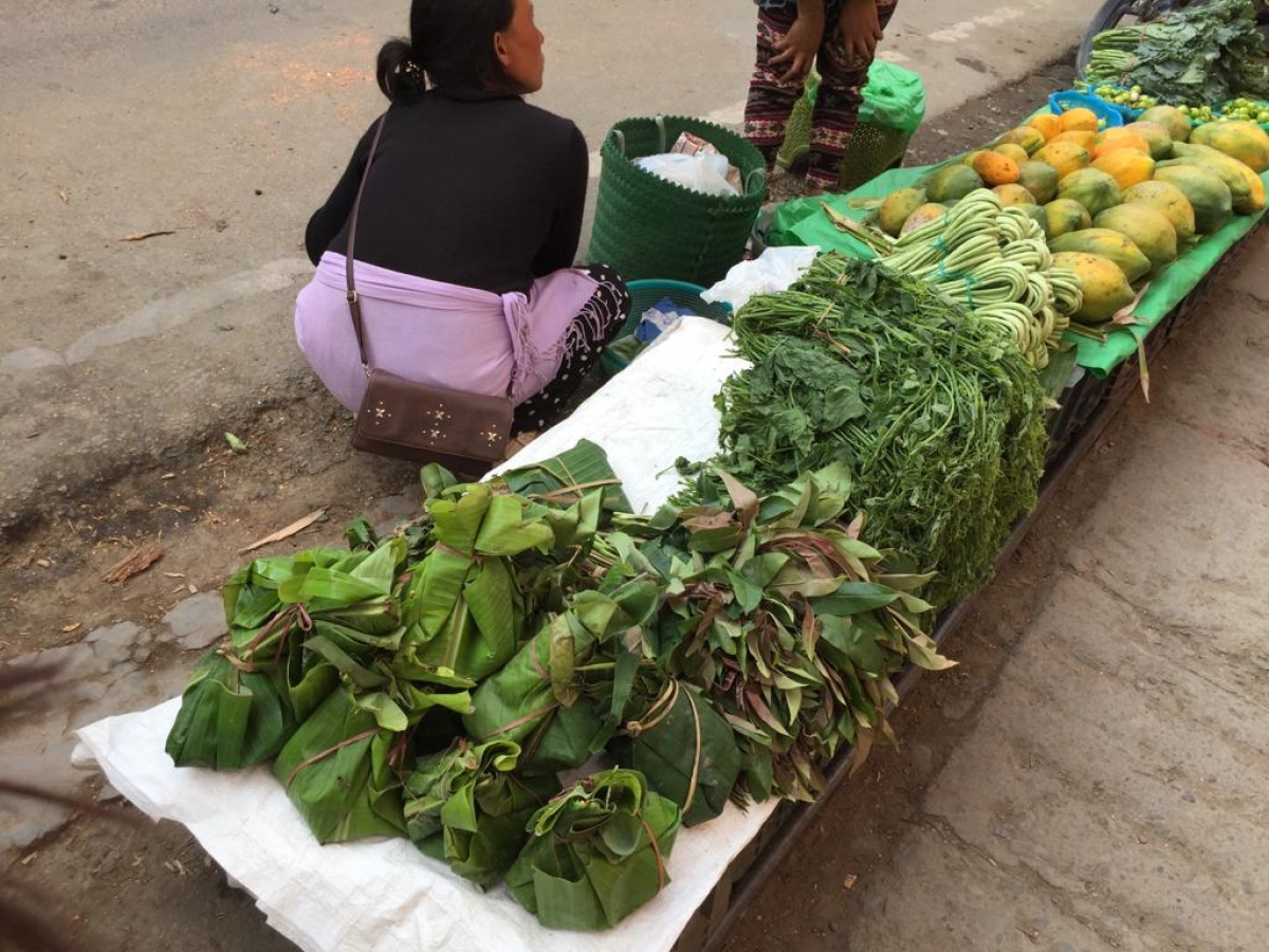 A vendor selling vegetables wrapped in banana leaves at a market in Kohima, Nagaland Medolenuo Ambrocia