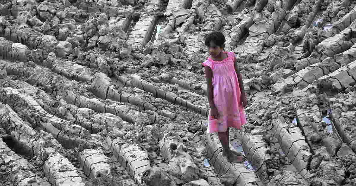 This file photo shows a girl standing in a dry lake in the Dala township, on the outskirts of Yangon. (AFP Photo)