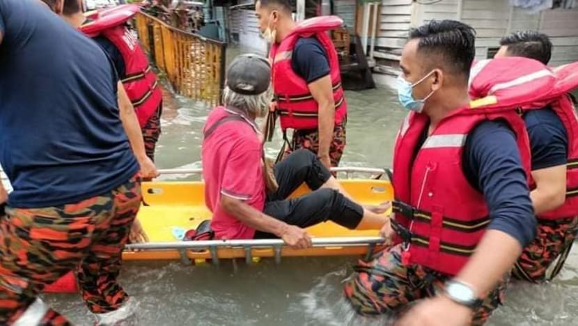 Fire and Rescue Department personnel assisting a flood victim in the Klang Valley on Monday (Mar 7). (Photo: Facebook/FIre and Rescue Department Malaysia)