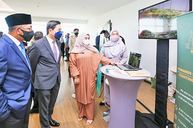 Minister at the Prime Minister’s Office and Minister of Finance and Economy II Dato Seri Setia Dr Awang Haji Mohd Amin Liew bin Abdullah and Minister of Development Dato Seri Setia Ir Awang Haji Suhaimi bin Haji Gafar being briefed during the exhibition. PHOTOS: BAHYIAH BAKIR
