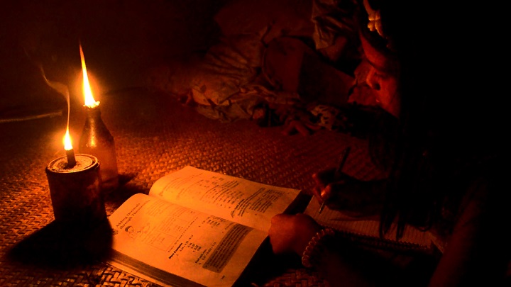 Joy Dominquez studies by candlelight. Gregg Yan/WWF