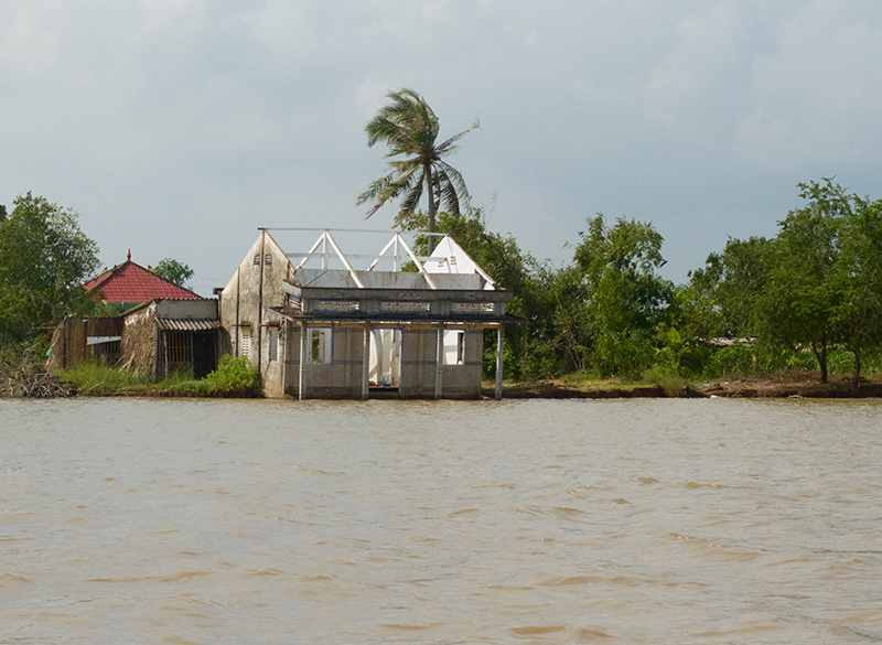 A house that is about to fall into the river in Ca Mau.