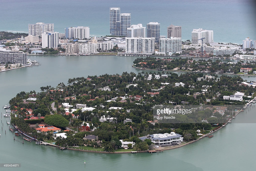 Single family homes on islands and condo buildings on ocean front property are seen in the city of Miami Beach June 3, 2014 in Miami, Florida. According to numerous scientists, south Florida could be flooded by the end of the century as global warming continues to melt the Arctic ice, in turn causing oceans to rise. U.S. President Barack Obama and the Environmental Protection Agency yesterday announced a rule that would reduce the nation's biggest source of pollution, carbon emissions from power plants, 30% by 2030 compared to 2005 levels. It is widely believed that these emissions are a main cause of global warming.