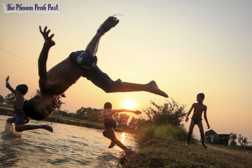 Children try to escape the afternoon heat by playing in a canal in Kandal province earlier this year. Vireak Mai