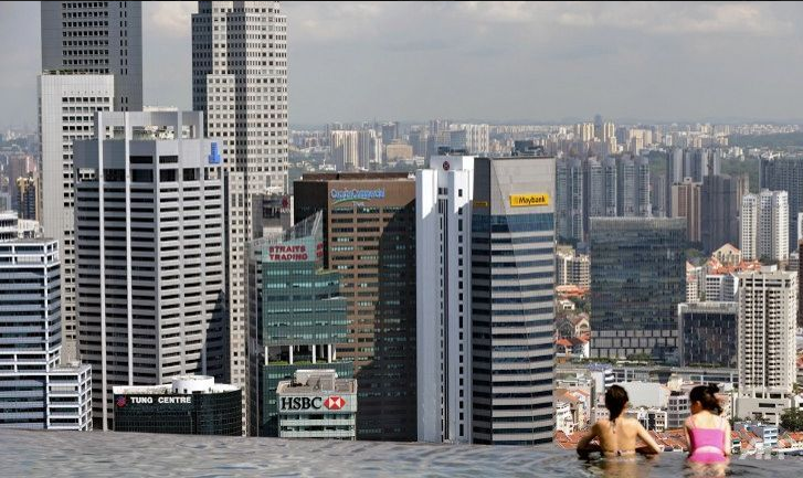 Guests of the Marina Bay Sands hotel in Singapore look over the city-state's financial district from a rooftop swimming pool. (Photo: AFP/Roslan Rahman)